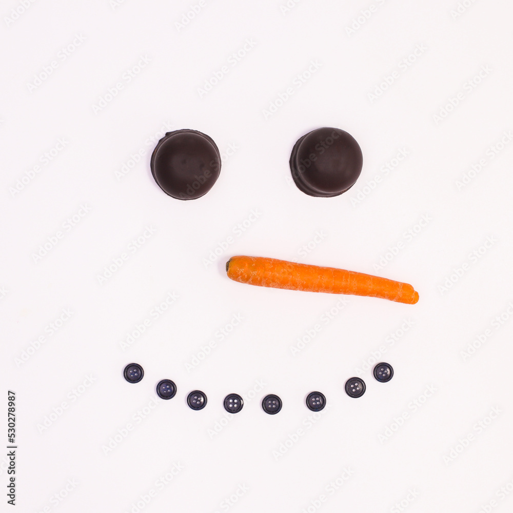 Creative snowman face made with cookies, carrot and buttons on white  background. Flat lat Christmas concept Stock Photo | Adobe Stock