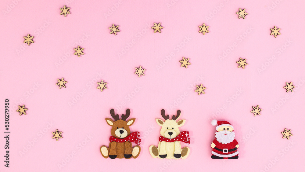 Christmas pastel pink background with Santa Clous and two reindeers. Flat lay