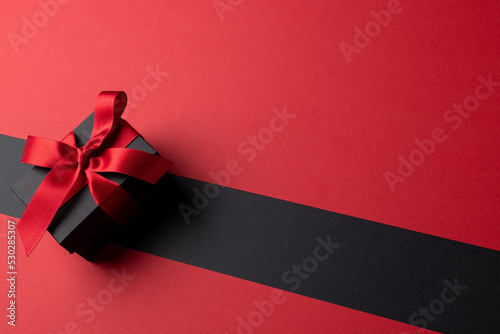 Composition of present with pink ribbon on gray and pink background