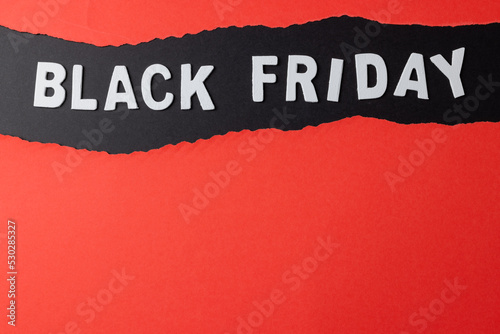Composition of pink paper cards and black friday text on gray background