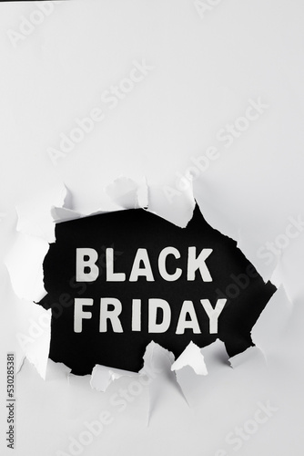 Composition of white paper card and black friday text
