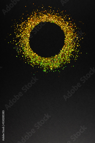 Composition of circle of gold spots on gray background