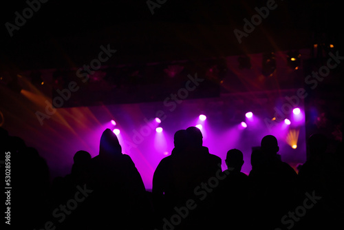Crowd at concert and blurred stage lights.