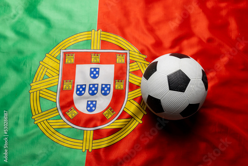 Composition of football over national flag of portugal