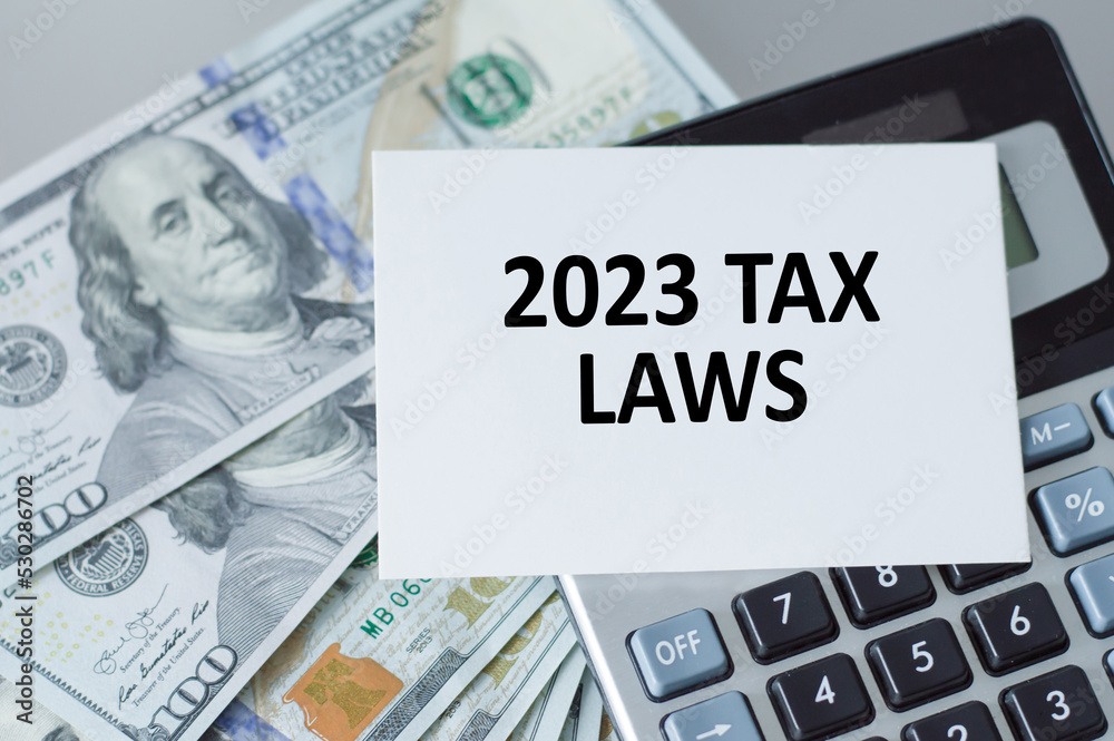 2023 tax laws text on the card on the calculator on the table. Business concept.