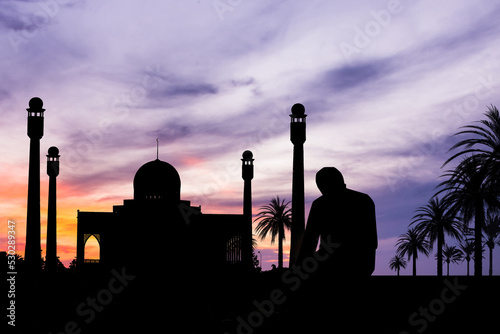 Islamic man praying Muslim Prayer in Twilight time