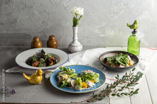 Three plates set of green healthy salad on white table Restaurant menu