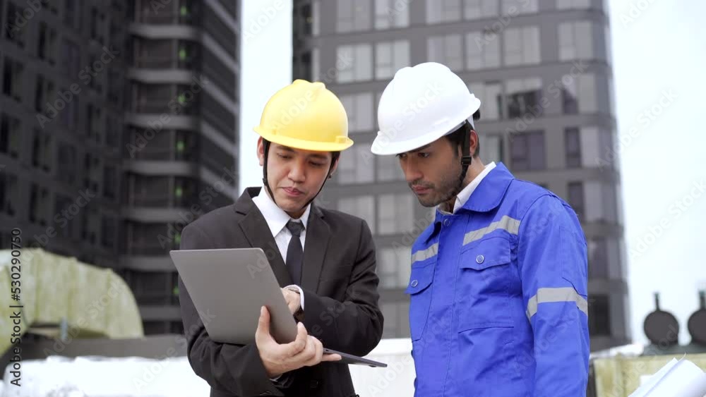 Asian businessman or project manager discussing with foreman or engineer. Asian businessman or project manager discussing with foreman or engineer.