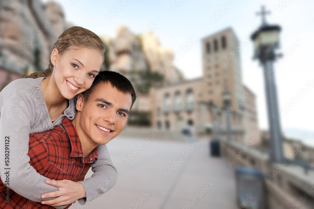 A cheerful happy couple in love visiting city centre tourists travelling and dating outdoors
