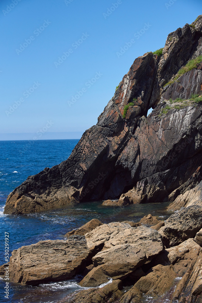 Luarca, Asturias, Spain; June 16, 2022; A beautiful sea view on the coast of Luarca.Cliffs of northern Spain.Lighthouse access to the port of Luarca, Asturias.