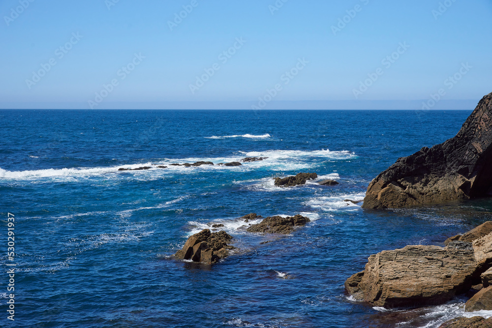 Luarca, Asturias, Spain; June 16, 2022; A beautiful sea view on the coast of Luarca.Cliffs of northern Spain.Lighthouse access to the port of Luarca, Asturias. Luarca, Asturias, Spain; June 16, 2022; A beautiful sea view on the coast of Luarca.Cliffs of northern Spain.Lighthouse access to the port of Luarca, Asturias.