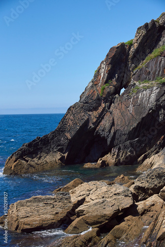 Luarca, Asturias, Spain; June 16, 2022; A beautiful sea view on the coast of Luarca.Cliffs of northern Spain.Lighthouse access to the port of Luarca, Asturias.