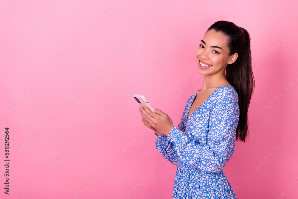 Closeup photo of young smiling businesswoman lady holding phone chatting online camera isolated on pink color background Closeup photo of young smiling businesswoman lady holding phone chatting online camera isolated on pink color background