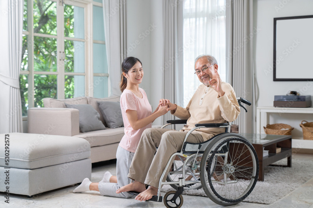 Daughter is caring for and encouraging father who is sick and unable to walk in wheelchair. Daughter is caring for and encouraging father who is sick and unable to walk in wheelchair.