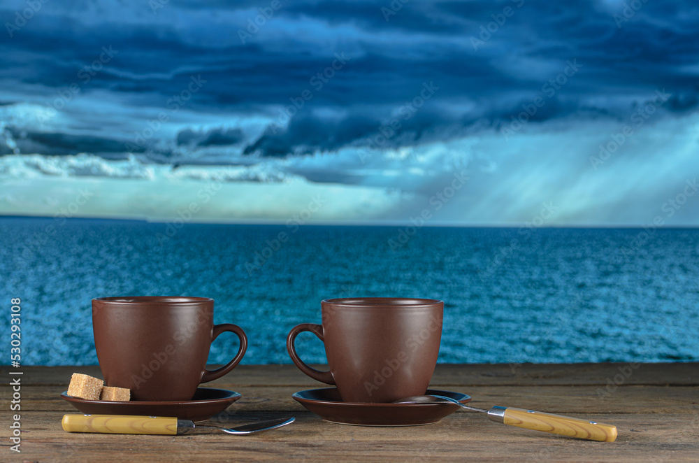 Two cups of tea on the background of a beautiful lake