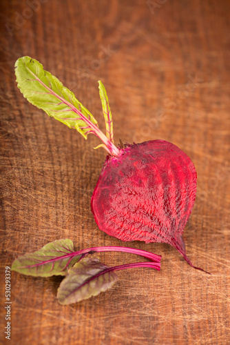 Red beet with leaves or beetroot on the wooden photo
