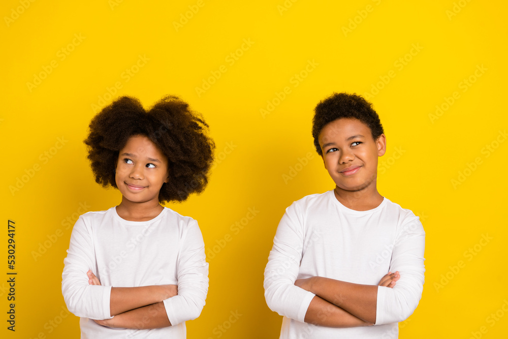 Photo of funky dreamy schoolgirl schoolboy wear white shirts arms folded empty space isolated yellow color background Photo of funky dreamy schoolgirl schoolboy wear white shirts arms folded empty space isolated yellow color background