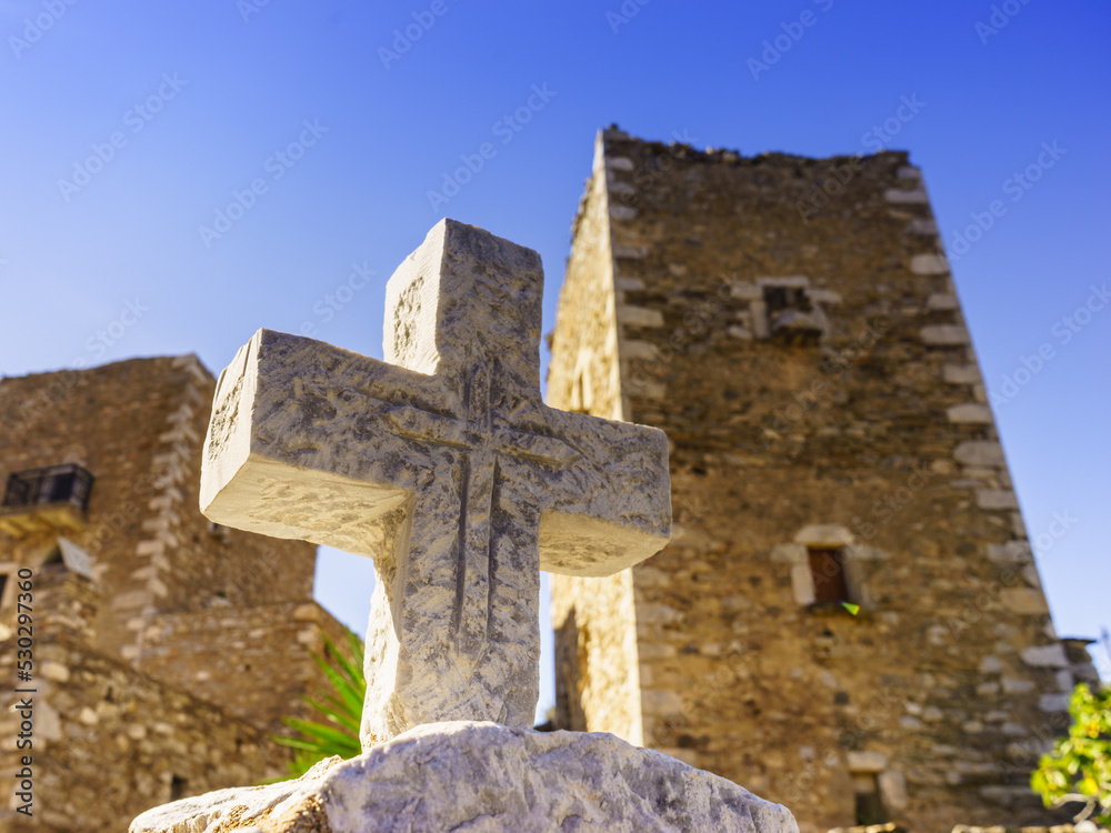 Greek stone cross and tower house, Greece