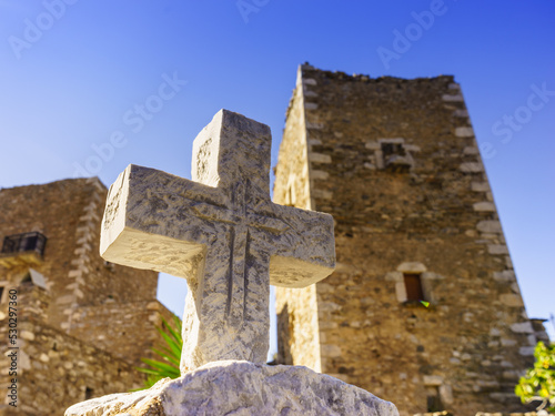 Greek stone cross and tower house, Greece