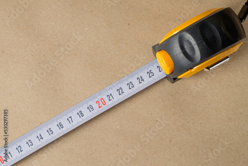 Cartridge meter. Yellow measuring tape isolated on craft paper background. With space for text