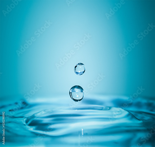 Falling water drops with splash in macro