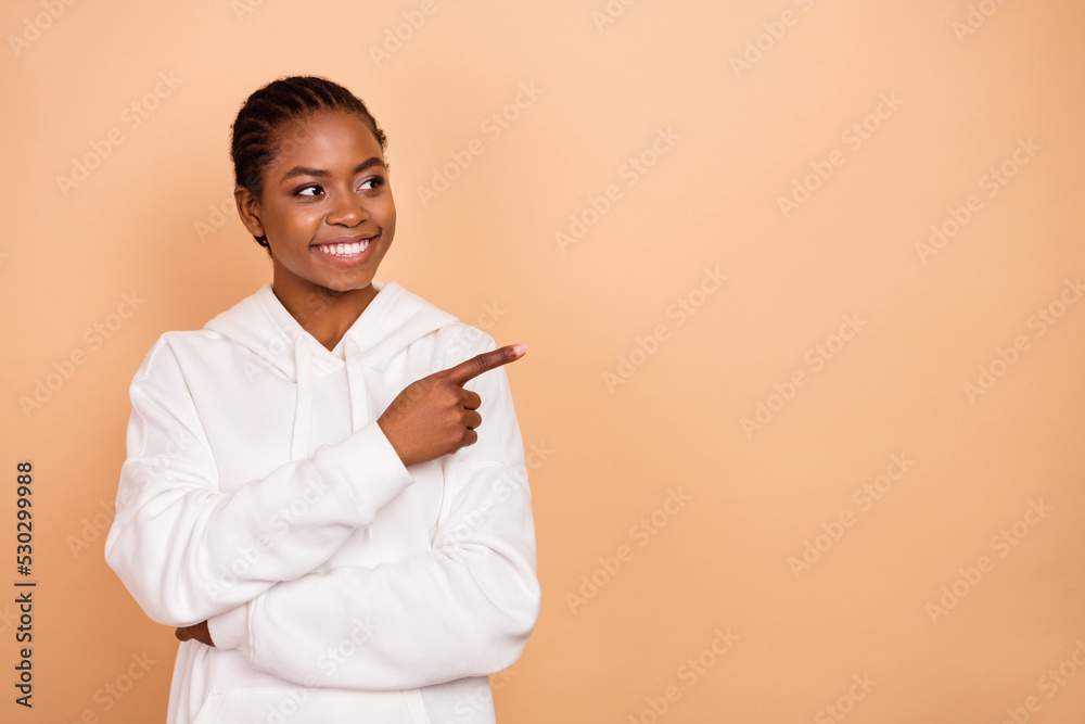 Photo of sweet young brunette lady indicate look promo wear white hoodie isolated on beige color background Photo of sweet young brunette lady indicate look promo wear white hoodie isolated on beige color background
