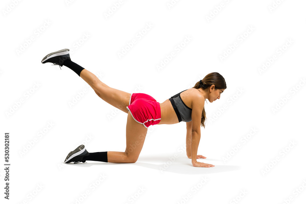 Healthy young woman practicing kickbacks exercises Healthy young woman practicing kickbacks exercises