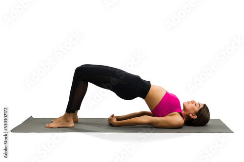 Fototapeta Naklejka Na Ścianę i Meble -  Sporty young woman training yoga over a white background