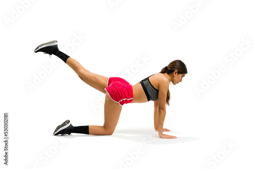 Healthy young woman practicing kickbacks exercises