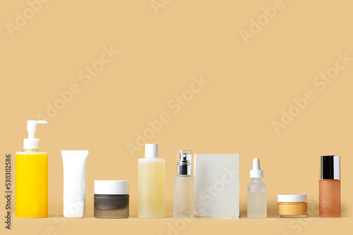 Cosmetic set of skincare routine for healthy radiant skin. Cleanser, gel, exfoliant, toner, essence, mask, serum,  cream and spf tretment on  on beige background. Beauty concept photo