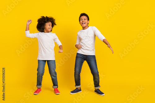 Fototapeta Naklejka Na Ścianę i Meble -  Full size photo of excited funky pupils enjoy dancing disco isolated on yellow color background