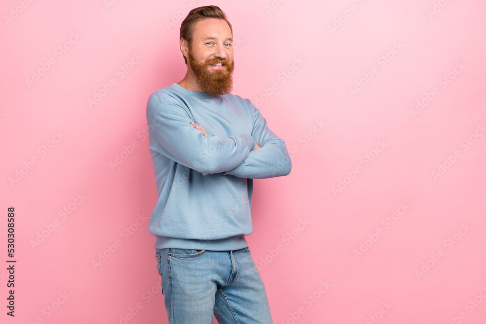 Portrait photo of young redhair man wear blue sweater folded hands confident professional empty space isolated on pink color background