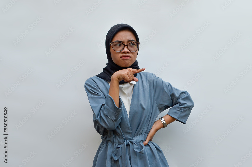 a young woman is pointing a fingers isolated on white background a young woman is pointing a fingers isolated on white background