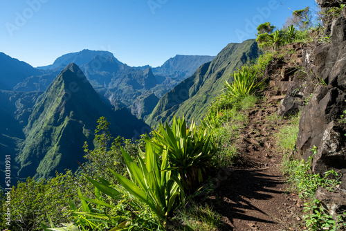 View of the mountain peaks and tourist path on the hill, in Reunion Island in the summertime