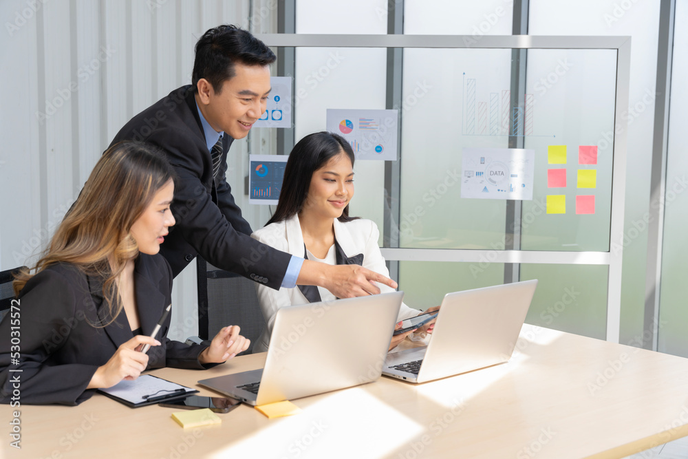 A group of young Asian businessmen Talking and planning work happily and have fun at the company's office A group of young Asian businessmen Talking and planning work happily and have fun at the company's office