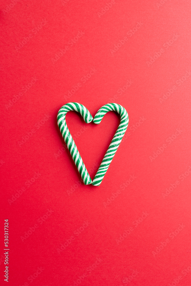 Two christmas canes in the midle over bright red background Two christmas canes in the midle over bright red background