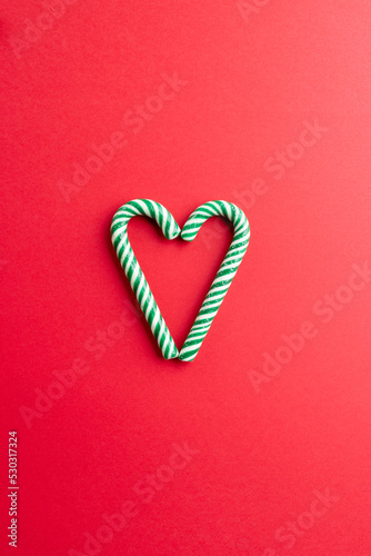Two christmas canes in the midle over bright red background
