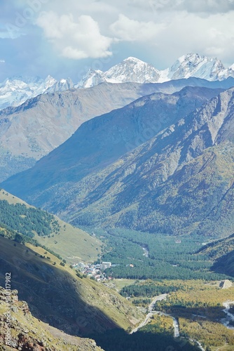 Mountain landscape of the Caucasian ridge with snow lying on them.