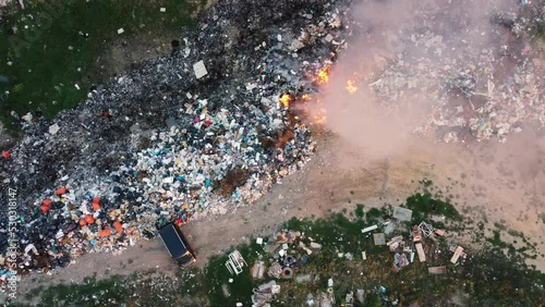 Air pollution by burning garbage. Drone footage of burning trash at garbage dump