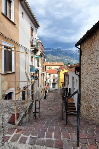 A narrow street between the old stone houses of Pratola Peligna, a medieval village in the Abruzzo region of Italy. photo