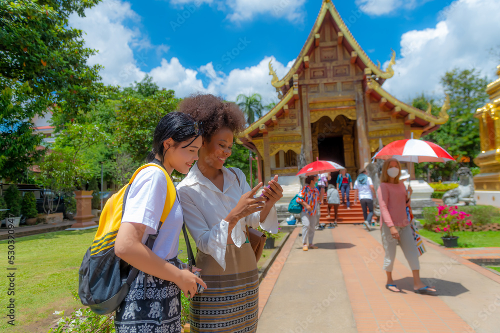 Foreign female tourists visit Wat Phra Singh, a famous tourist attraction and attraction in Chiang Mai, Thailand.