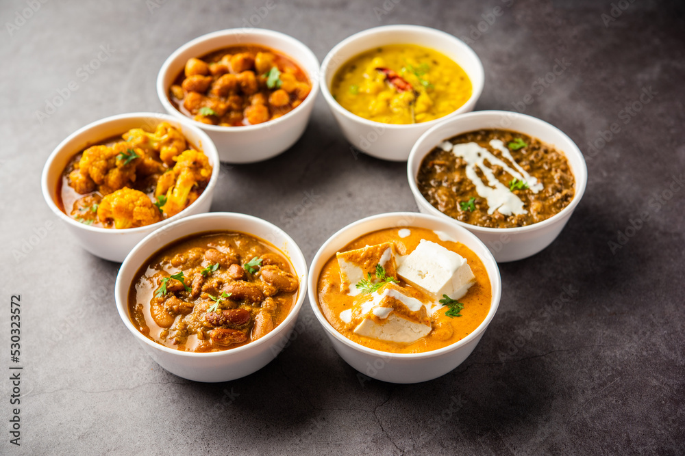 Group of Indian vegetarian dishes, hot and spicy Punjabi cuisine meal assortment in bowls Group of Indian vegetarian dishes, hot and spicy Punjabi cuisine meal assortment in bowls