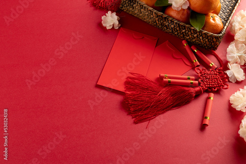 Composition of traditional chinese decorations and flowers on red background