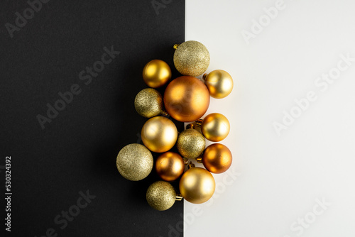 Composition of close up of new years baubles on black and white background