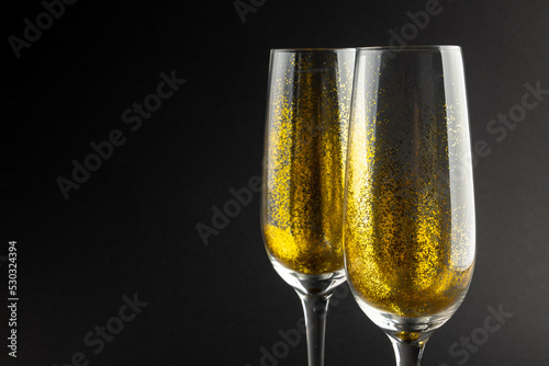 Composition of close up of new years champagne on black background