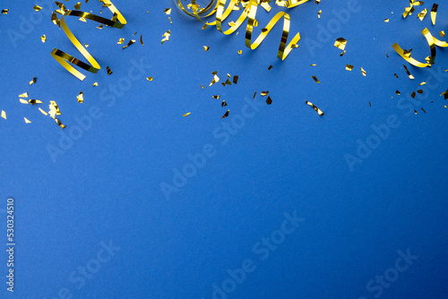 Composition of close up of new years decorations on blue background
