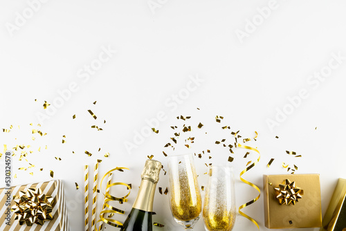 Composition of close up of new years champagne and decorations on white background