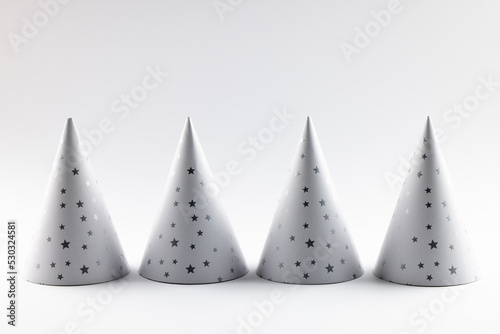 Composition of close up of new years hats on white background
