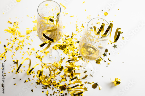 Composition of close up of new years champagne and decorations on white background
