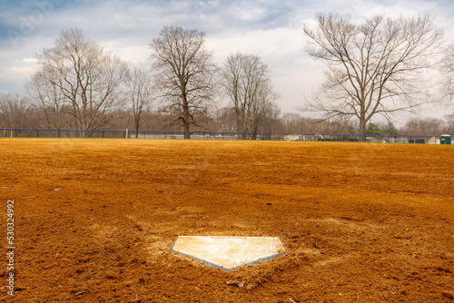 Obraz na płótnie View of typical nondescript high school softball clay infield looking from batters box toward the outfield